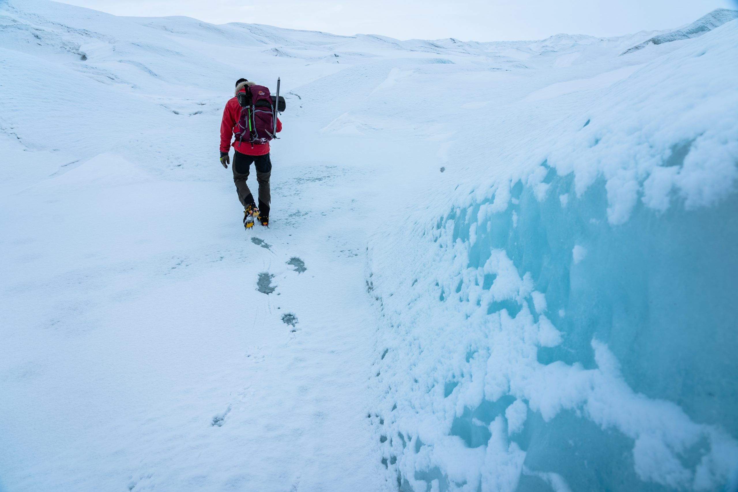 Hiker passing by big ice blocks on Greenland Ice Sheet - Photo by Alex Savu - Visit Greenland