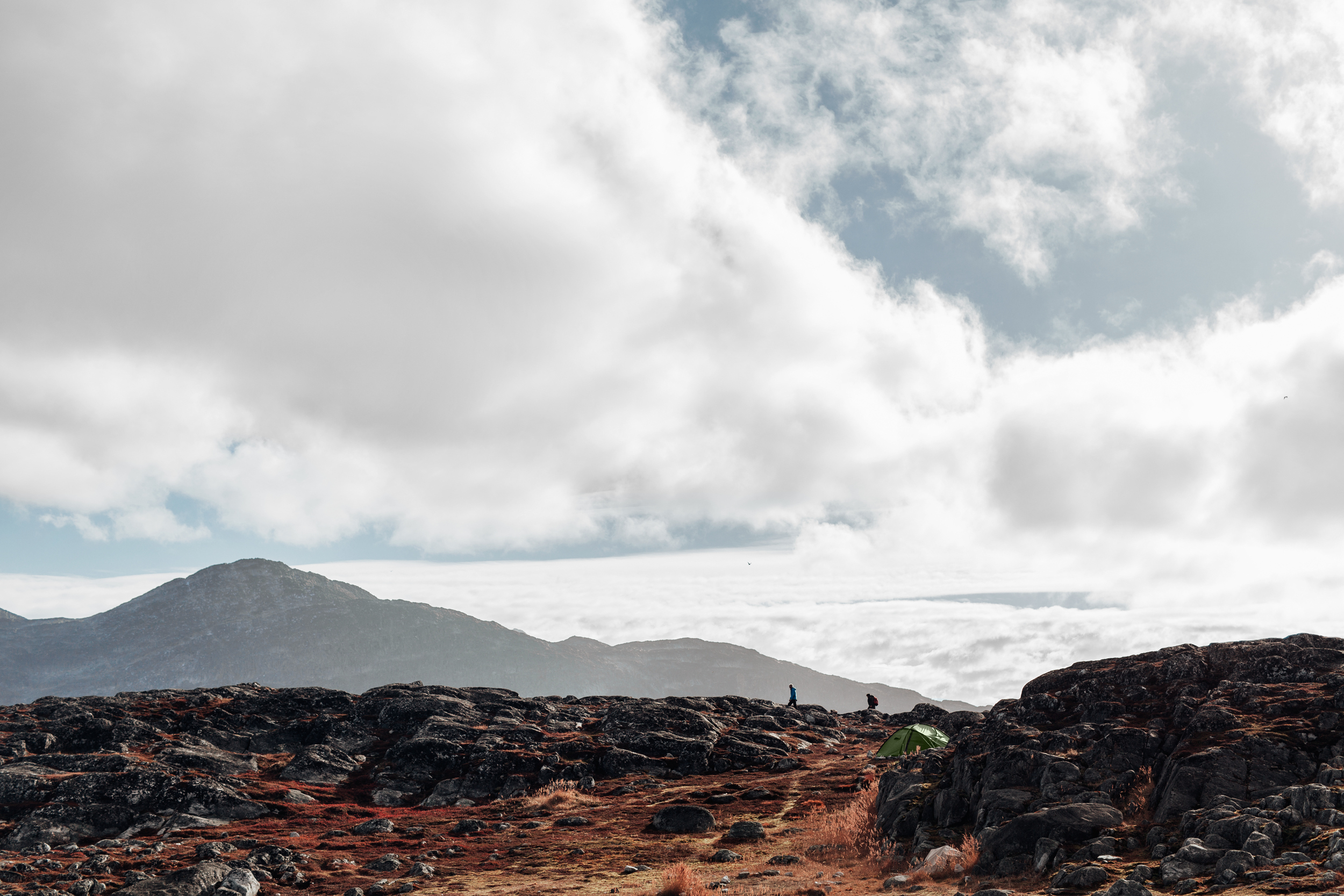 Two hikers and their tent on an autumn day in Nuuk in Greenland